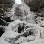 icicles and snow flow over the edge of the waterfall of the Blue Ridge Parkway